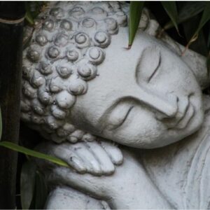 statua di pietra di ragazzo orientale che dorme